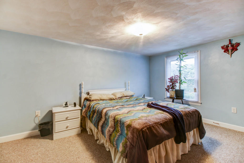 1400 Morgans Mill Road Goodview, VA 24095 - Photo 20 of 21 a bedroom with a bed and a window