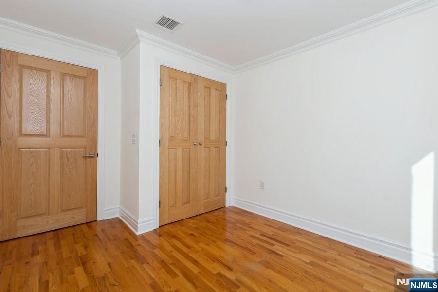 17 Meadow Road, Unit 405 Rutherford, NJ 07070 - Photo 11 of 18 a view of an empty room with wooden floor