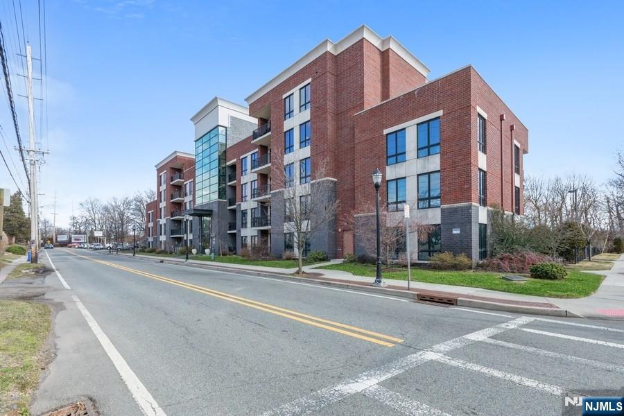 17 Meadow Road, Unit 405 Rutherford, NJ 07070 - Photo 14 of 18 a city street lined with buildings and trees