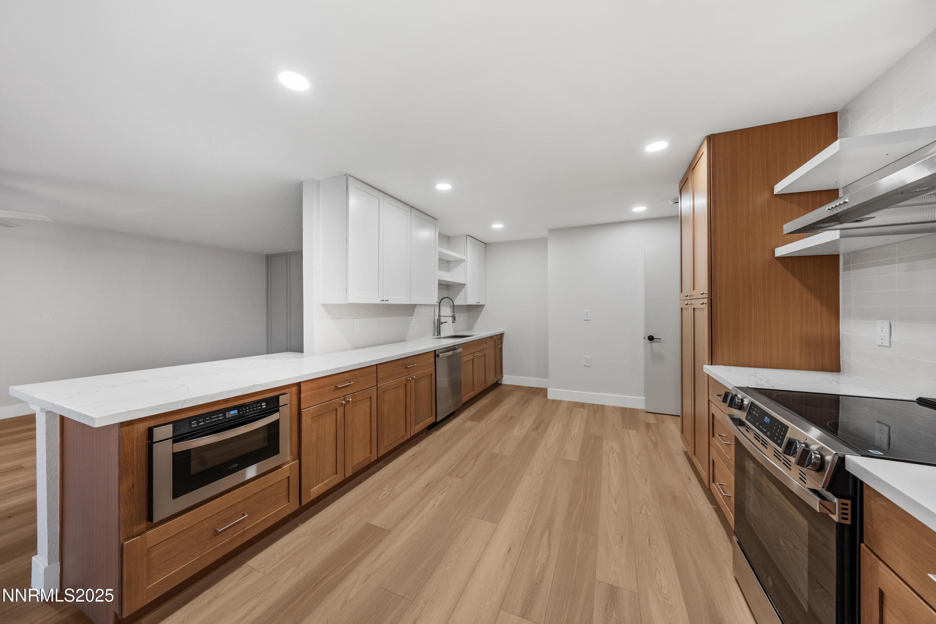 3465 Dawn Circle Sparks, NV 89431 - Photo 7 of 17 a kitchen with stainless steel appliances kitchen island granite countertop a stove a sink and a refrigerator