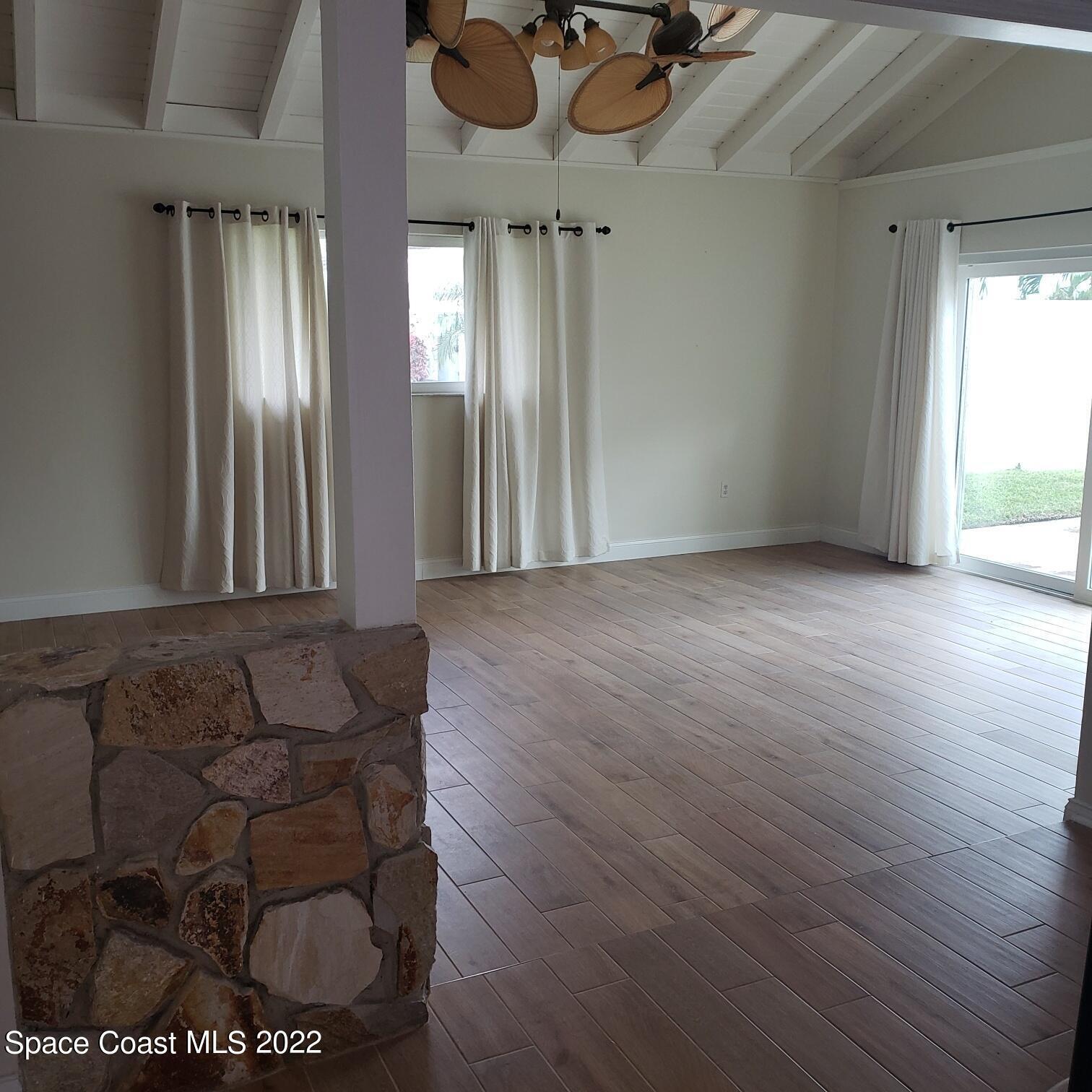 215 Andros Avenue Cocoa Beach, FL 32931 - Photo 14 of 55 a view of a livingroom with furniture and windows