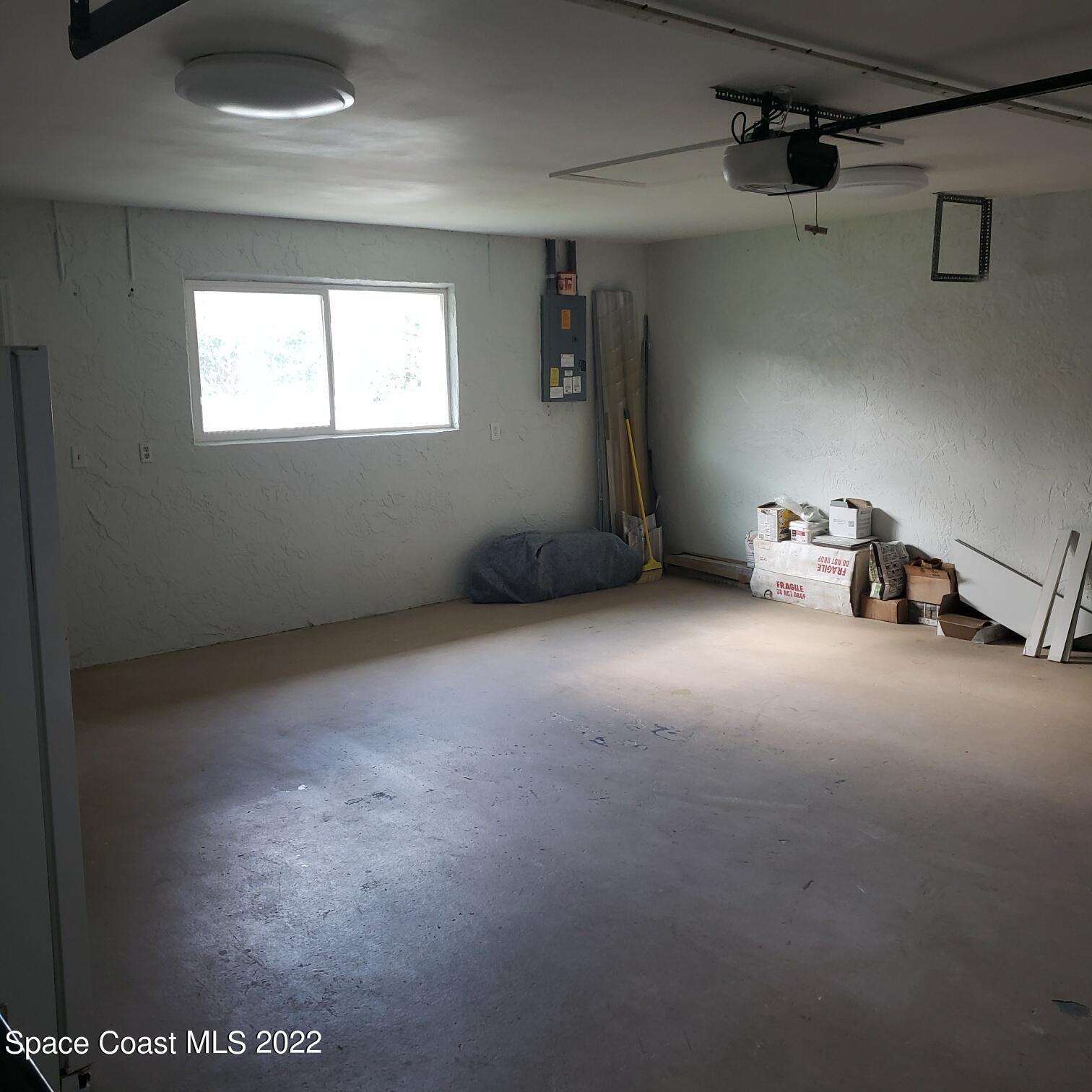 215 Andros Avenue Cocoa Beach, FL 32931 - Photo 19 of 55 a view of an empty room with a window