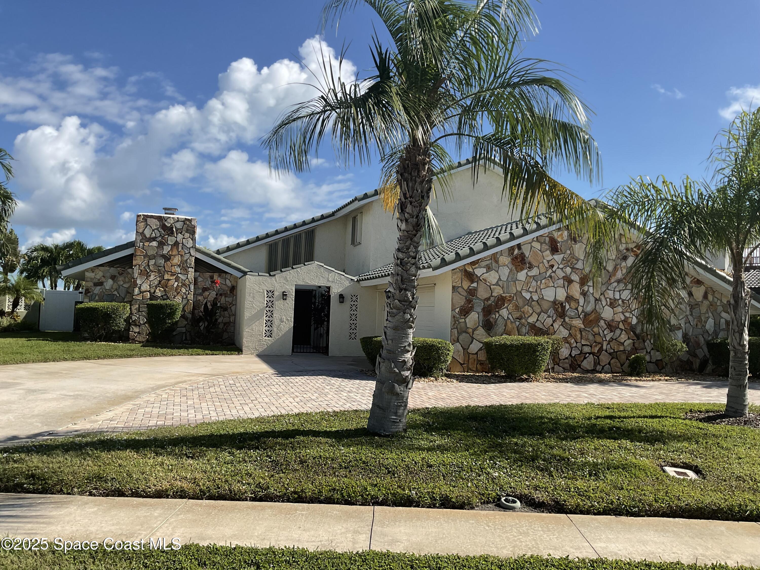 215 Andros Avenue Cocoa Beach, FL 32931 - Photo 3 of 55 a view of a house with a yard