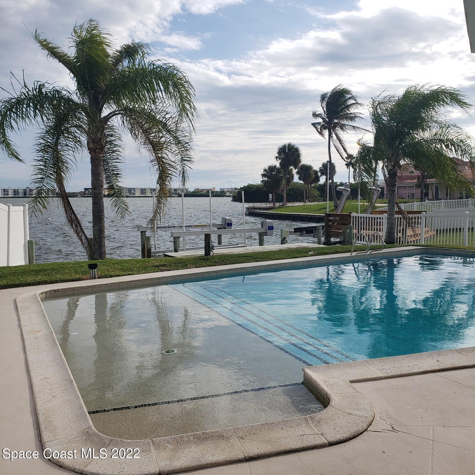 215 Andros Avenue Cocoa Beach, FL 32931 - Photo 33 of 55 a view of swimming pool with a yard and seating area