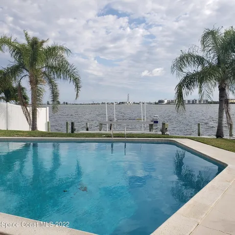 a view of staircase with lots of frames on wall and a window