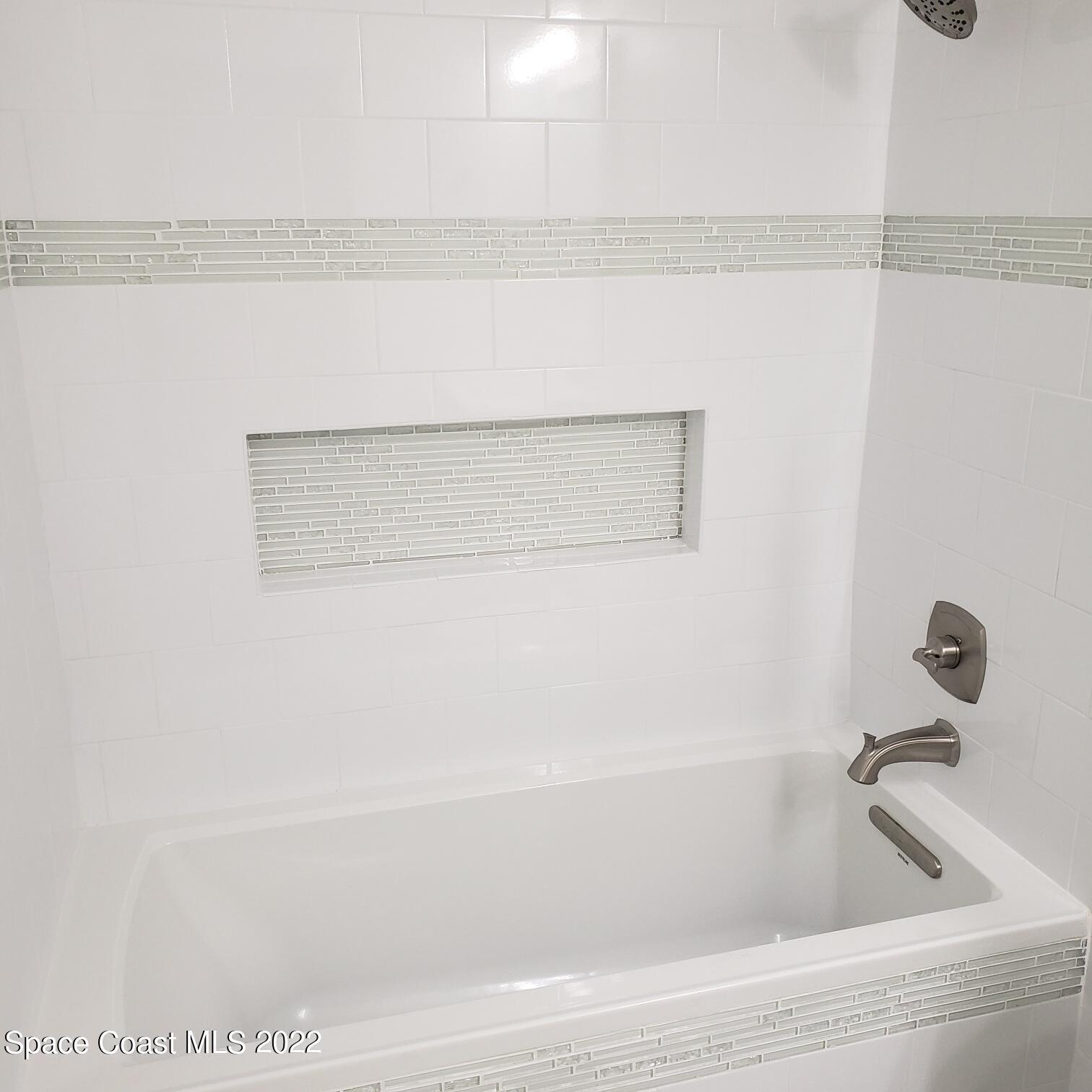 215 Andros Avenue Cocoa Beach, FL 32931 - Photo 42 of 53 a bathroom with a bathtub