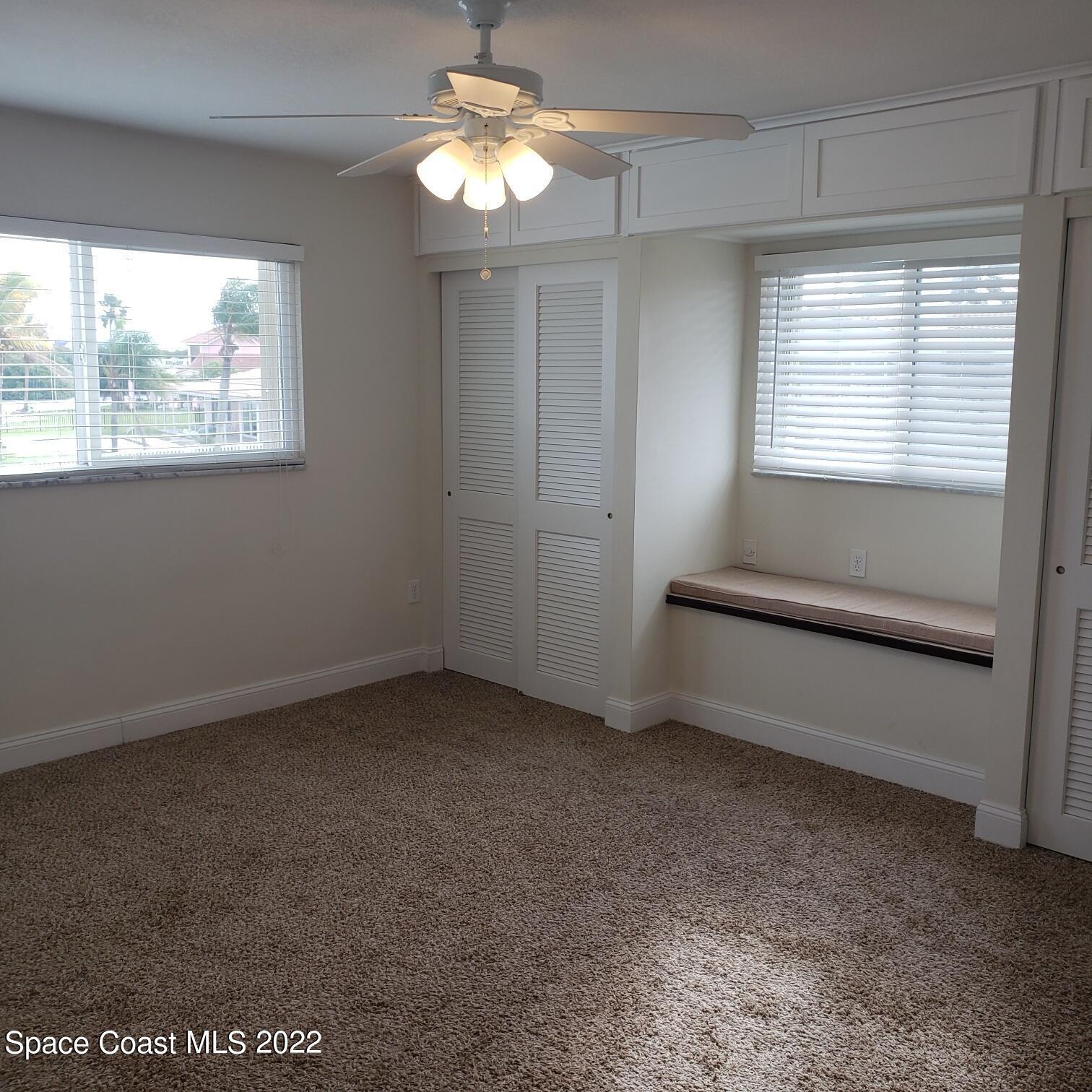 215 Andros Avenue Cocoa Beach, FL 32931 - Photo 45 of 53 a view of room with window and ceiling fan