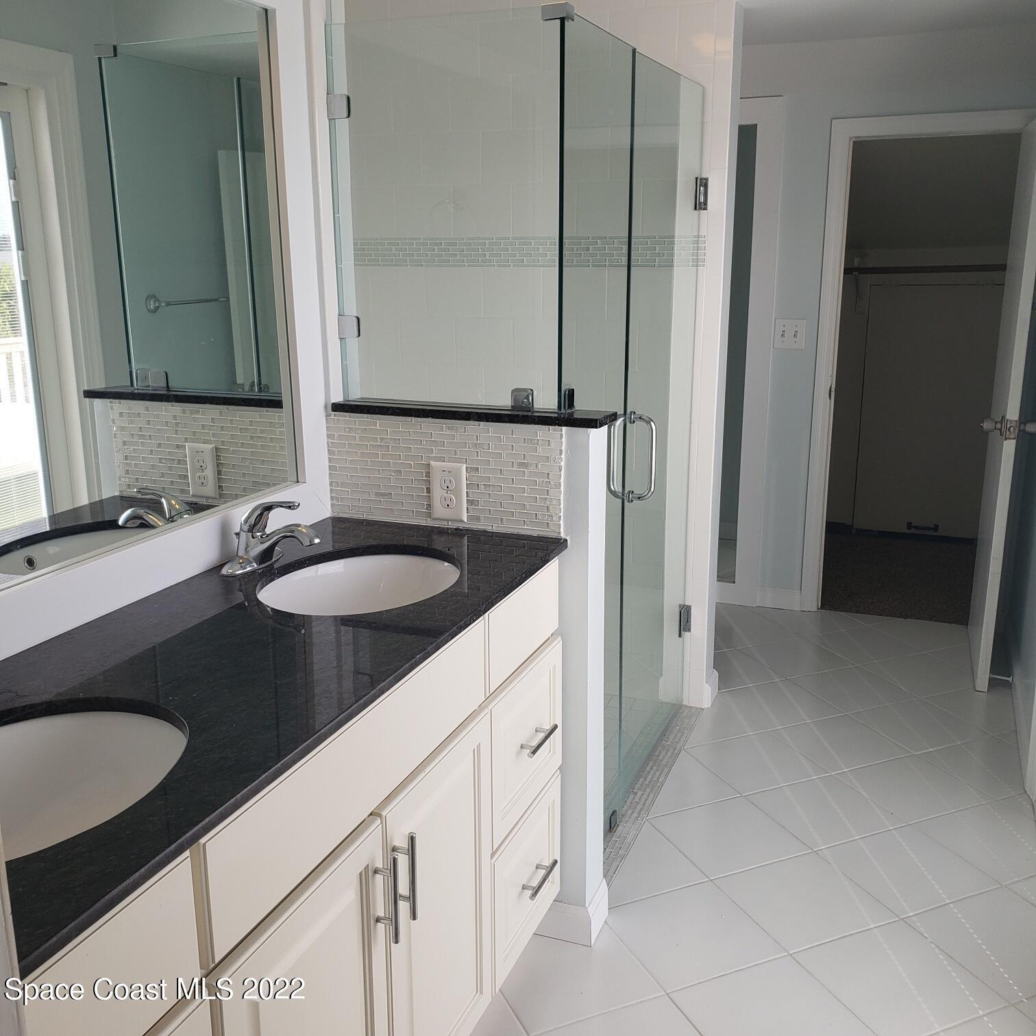 215 Andros Avenue Cocoa Beach, FL 32931 - Photo 47 of 53 a bathroom with a sink and a mirror