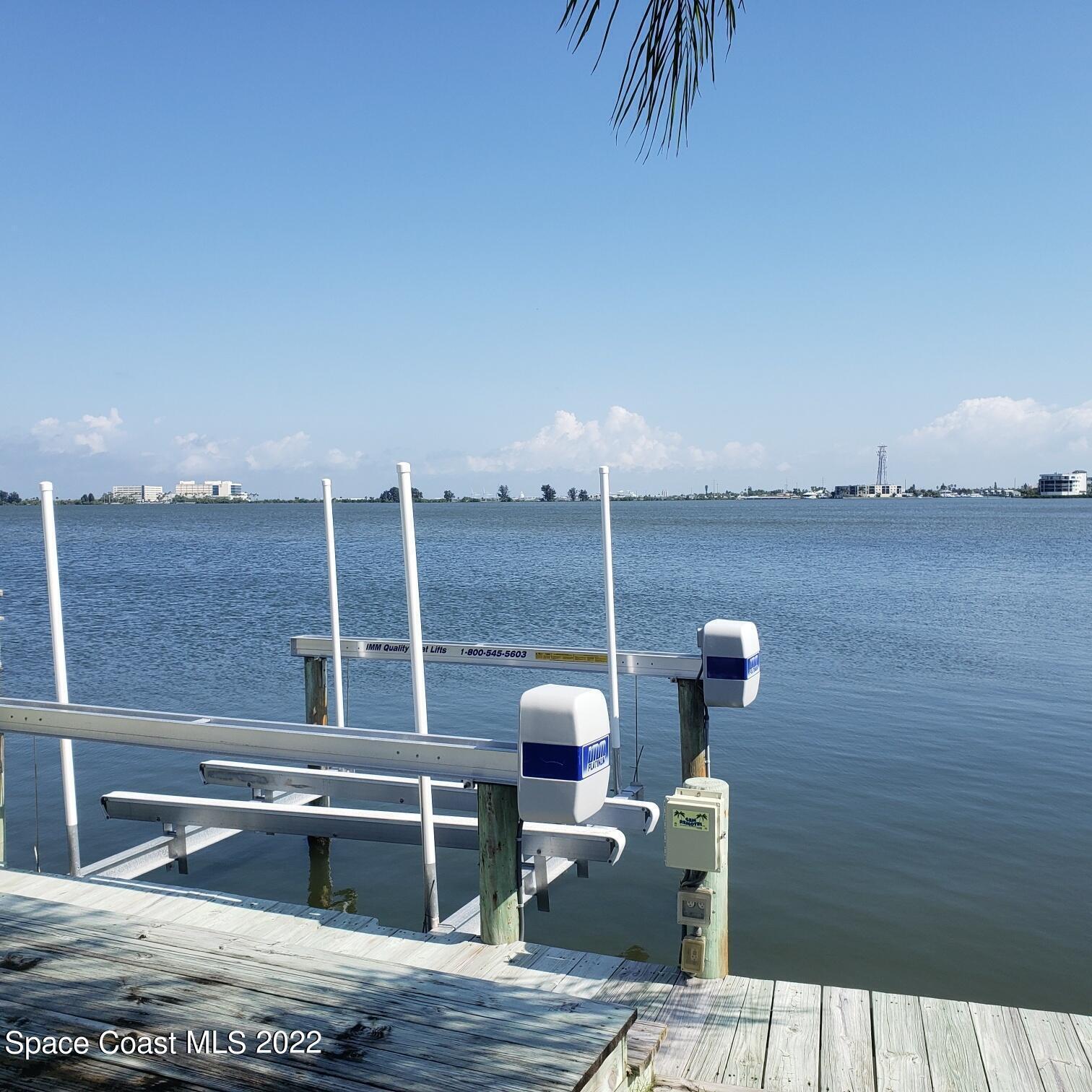 215 Andros Avenue Cocoa Beach, FL 32931 - Photo 51 of 55 a roof deck with table and chairs
