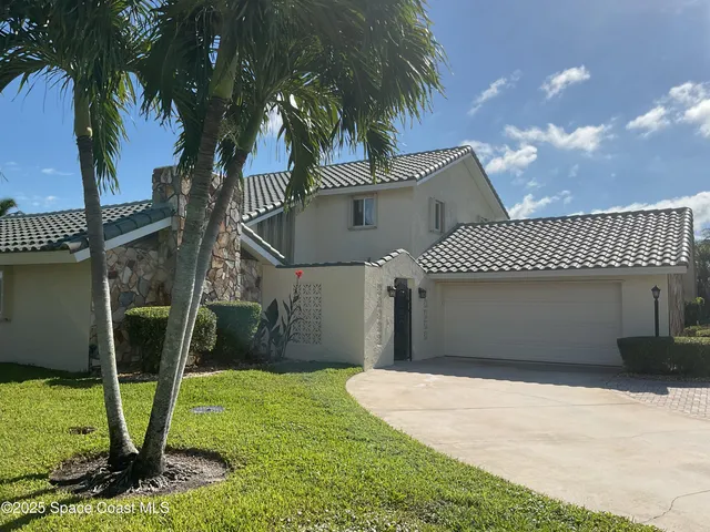 a backyard of a house with palm tree