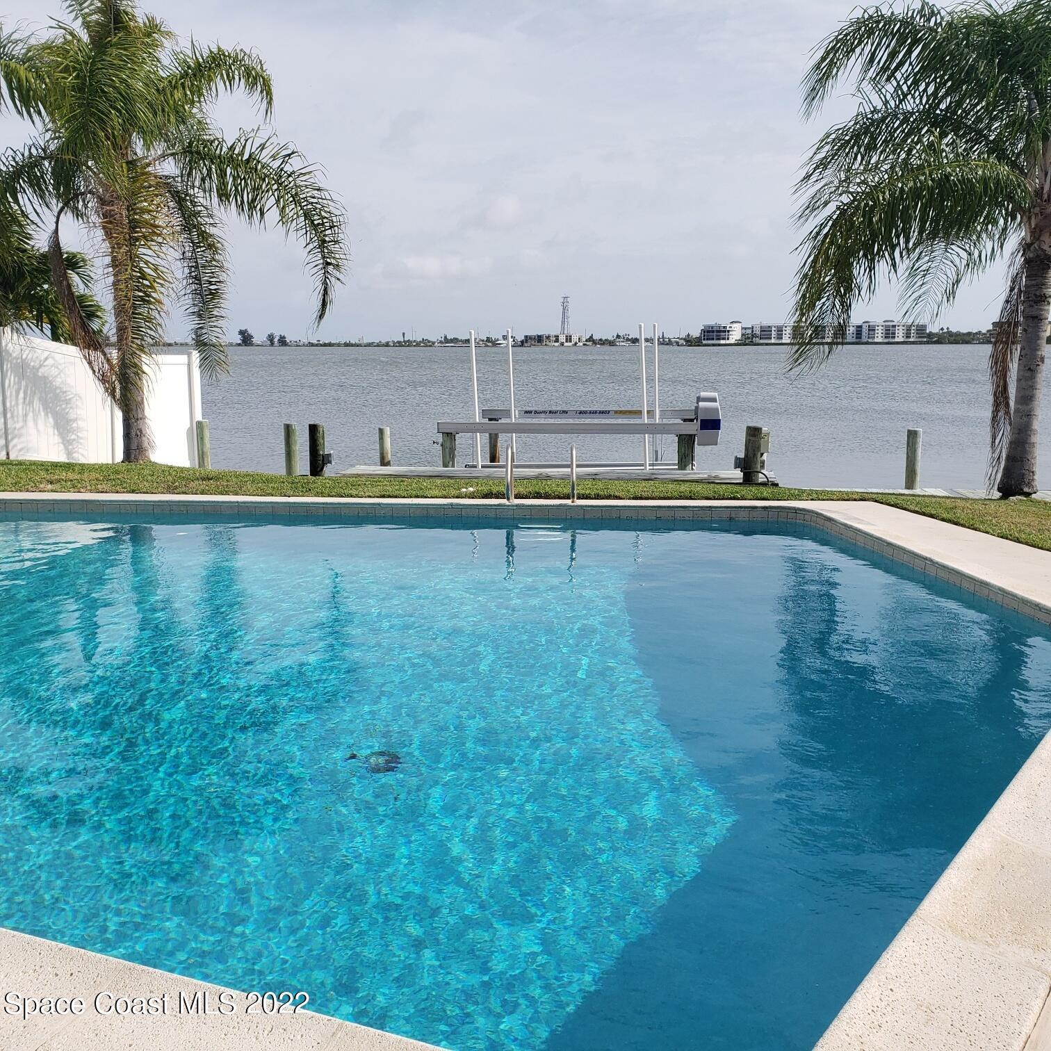 215 Andros Avenue Cocoa Beach, FL 32931 - Photo 10 of 55 a view of a swimming pool and a chair