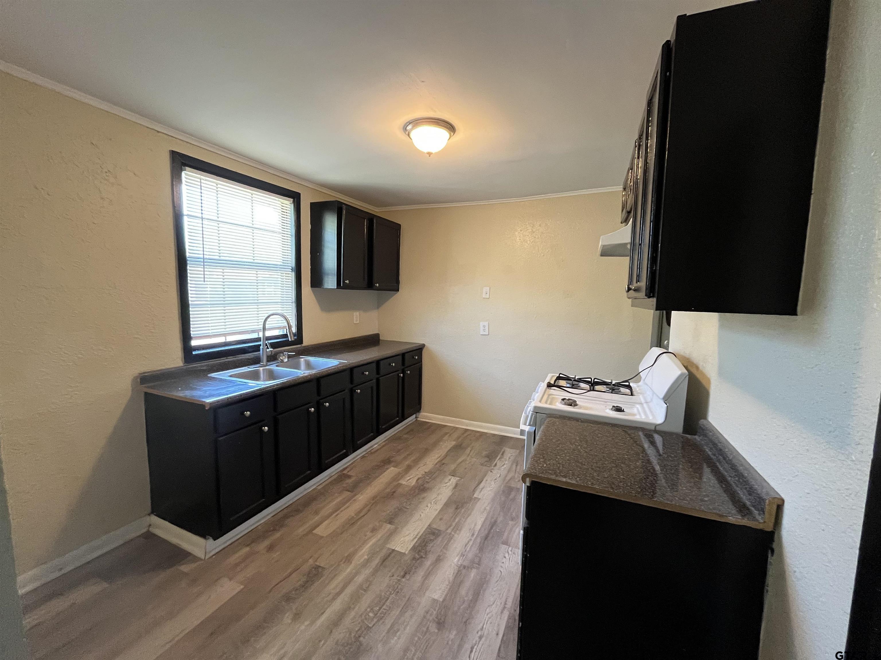 3312 North Luberta Street Tyler, TX 75702 - Photo 4 of 8 a bed room with a bed and a television