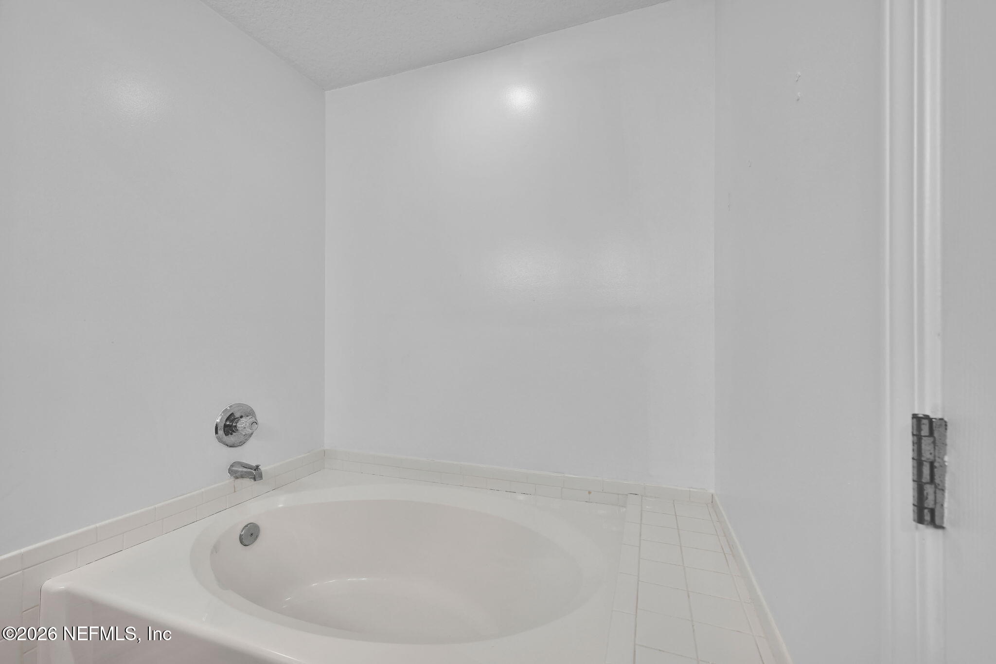 1110 Woodlawn Road, Unit D St. Augustine, FL 32084 - Photo 32 of 40 a white bath tub sitting in a bathroom