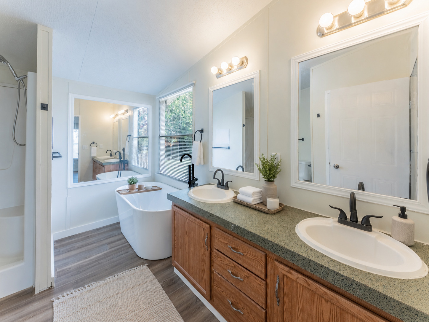 171 Railyard Drive Kyle, TX 78640 - Photo 14 of 20 a bathroom with a granite countertop sink double mirror and bathtub