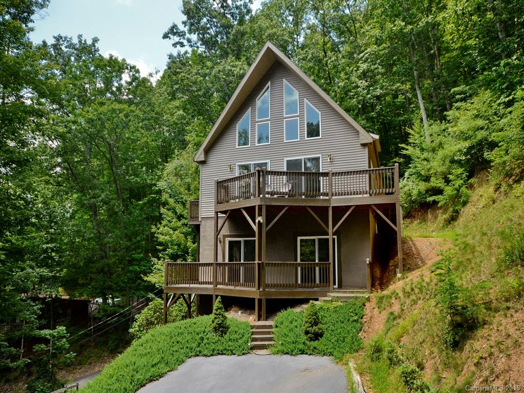 668 Mouzon Road Waynesville, NC 28785 - Photo 1 of 24 a view of a big house with a small yard plants and large trees