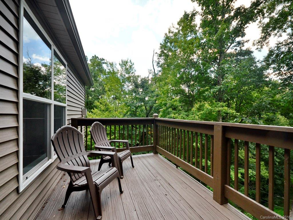 668 Mouzon Road Waynesville, NC 28785 - Photo 2 of 24 a view of balcony with wooden floor and outdoor seating