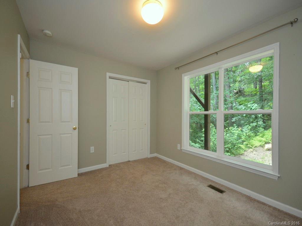 668 Mouzon Road Waynesville, NC 28785 - Photo 12 of 24 a view of an empty room with a window