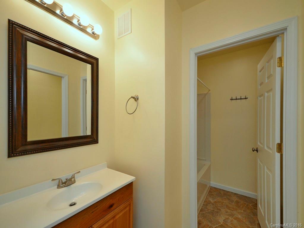 668 Mouzon Road Waynesville, NC 28785 - Photo 20 of 24 a bathroom with a sink a mirror a vanity and a shower
