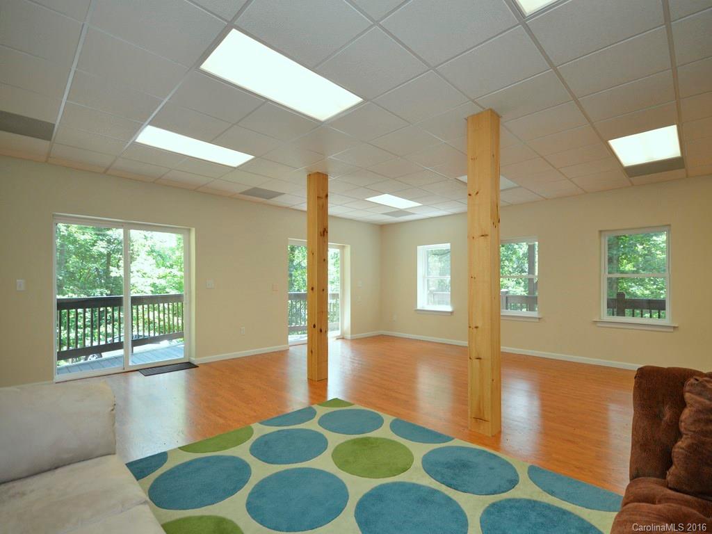 668 Mouzon Road Waynesville, NC 28785 - Photo 21 of 24 a living room with furniture and a rug