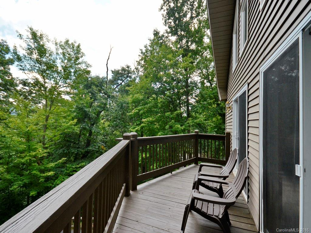 668 Mouzon Road Waynesville, NC 28785 - Photo 5 of 24 a view of balcony with wooden floor and outdoor seating