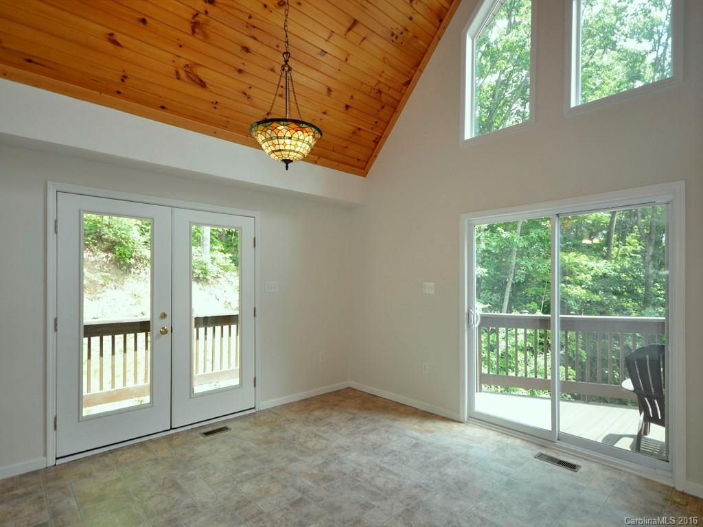 668 Mouzon Road Waynesville, NC 28785 - Photo 6 of 24 a view of an empty room with a window