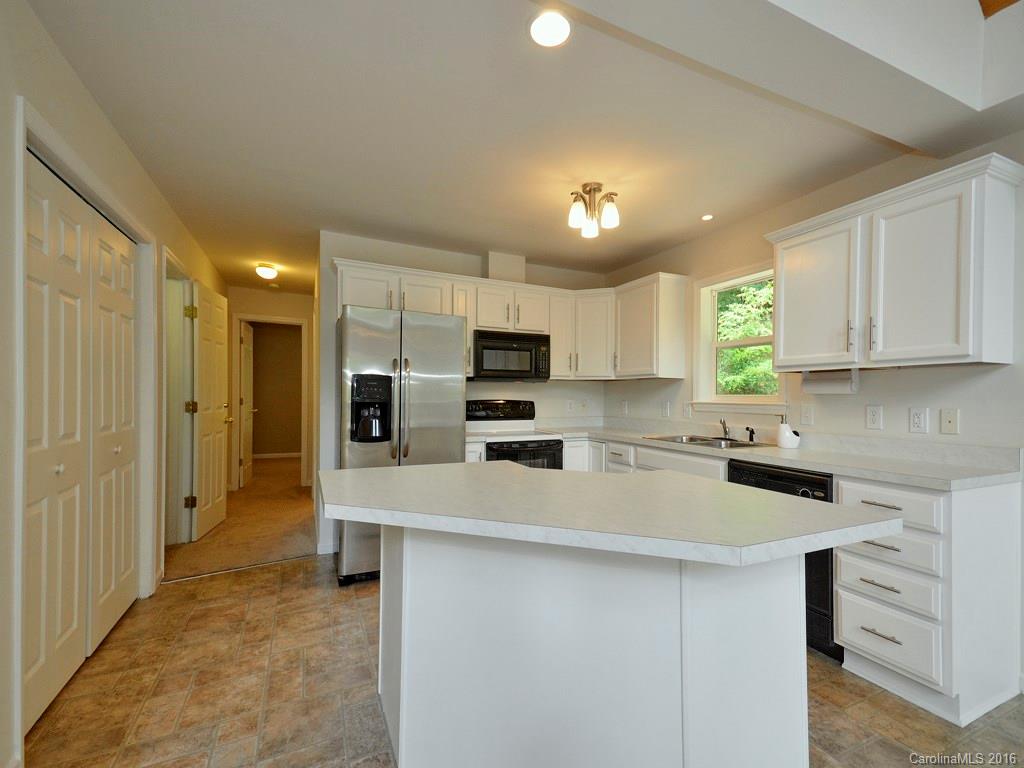 668 Mouzon Road Waynesville, NC 28785 - Photo 8 of 24 a kitchen with a sink a counter top space stainless steel appliances and cabinets