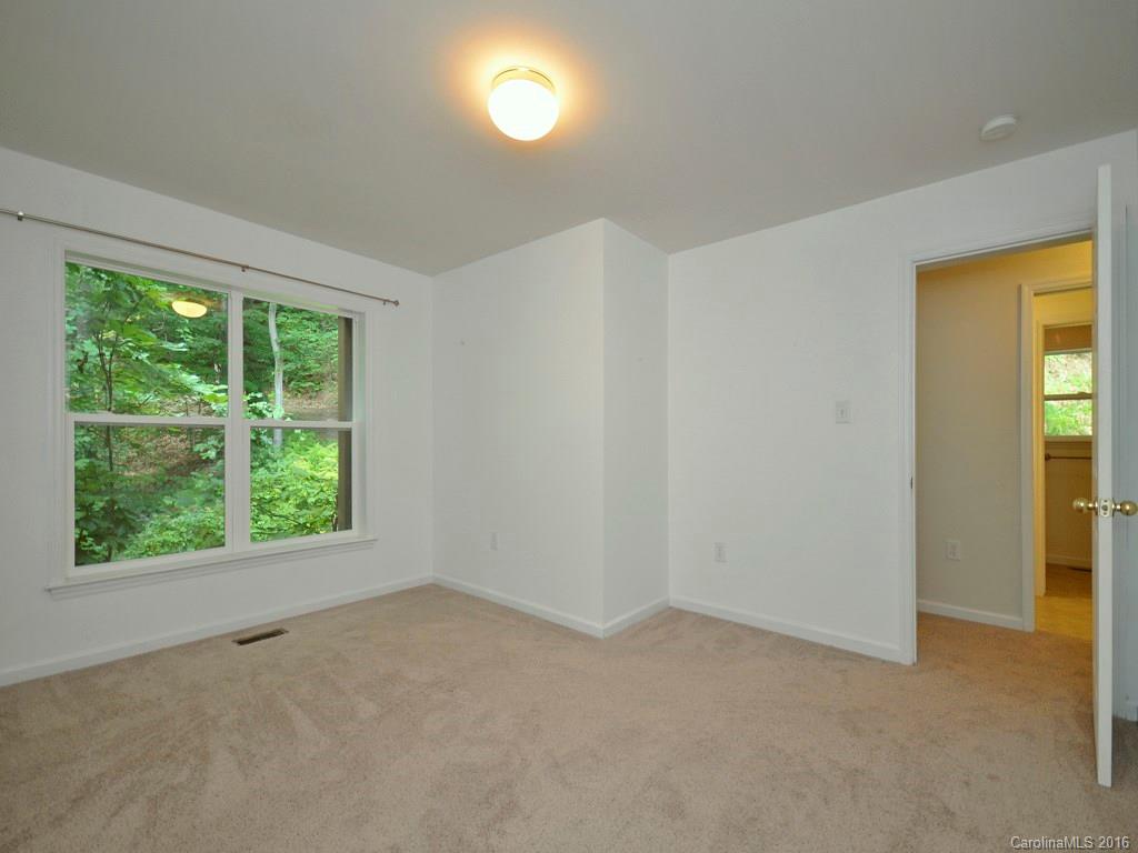 668 Mouzon Road Waynesville, NC 28785 - Photo 10 of 24 a view of an empty room with a window