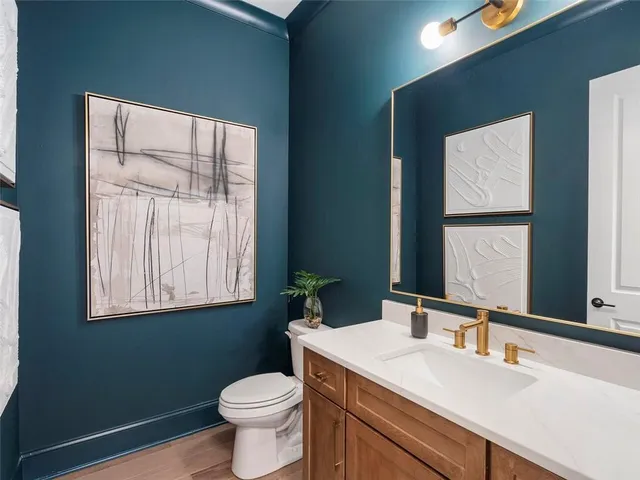 a bathroom with a toilet sink and mirror