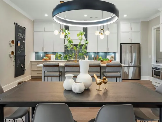a living room with dining table and chairs