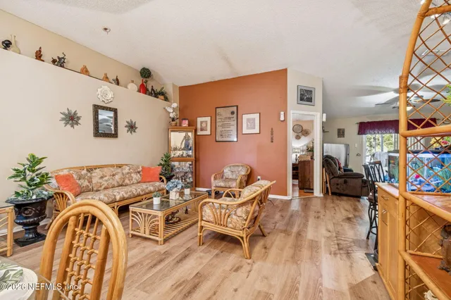 a view of a dining room with furniture and a chandelier
