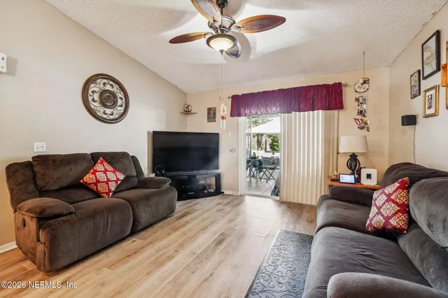 a kitchen with stainless steel appliances kitchen island granite countertop a sink cabinets and wooden floor