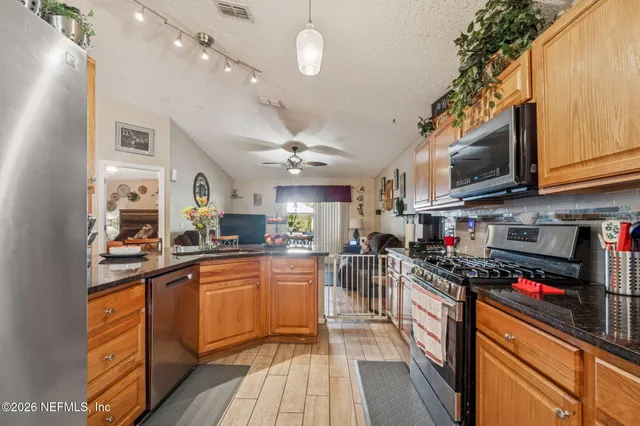 a kitchen with stainless steel appliances a refrigerator stove and microwave