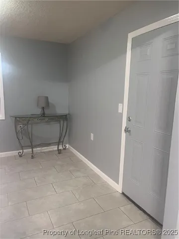 a view of an empty room and fire place