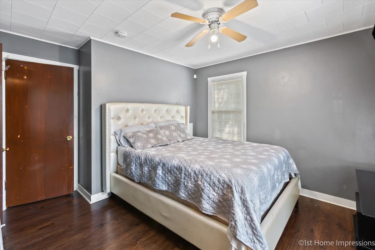 2425 South 13th Avenue Broadview, IL 60155 - Photo 9 of 13 a bedroom with a bed and a chandelier