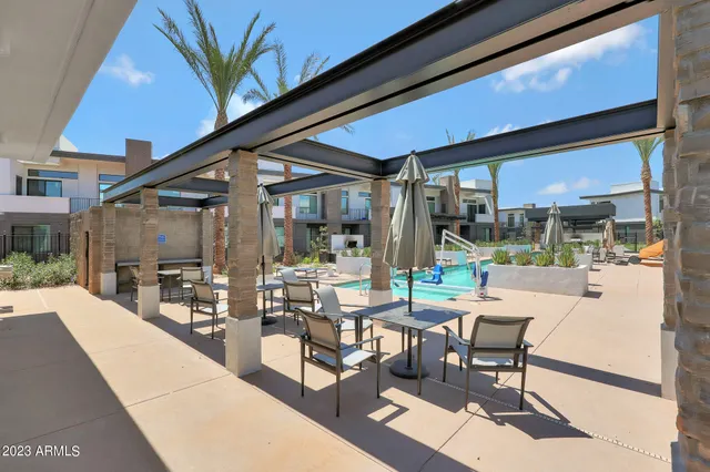 a house view with pool and chairs