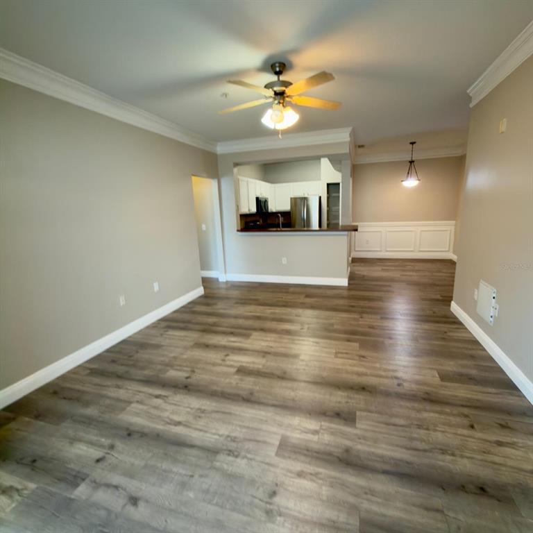12861 Madison Pointe Circle, Unit 101 Orlando, FL 32821 - Photo 12 of 30 a view of an empty room with a kitchen