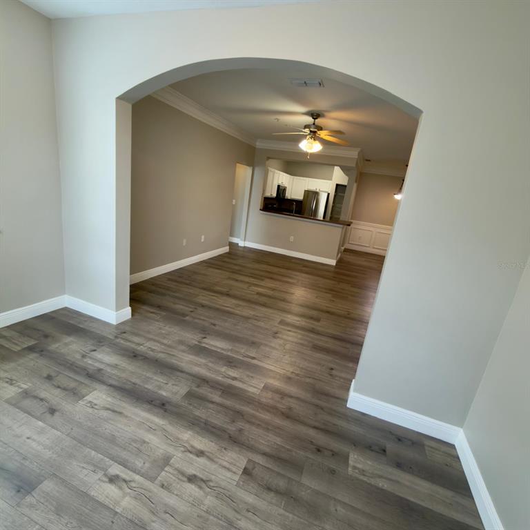 12861 Madison Pointe Circle, Unit 101 Orlando, FL 32821 - Photo 13 of 30 a view of a livingroom with wooden floor