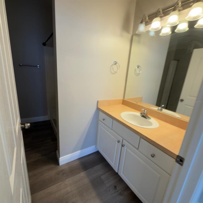 12861 Madison Pointe Circle, Unit 101 Orlando, FL 32821 - Photo 16 of 30 a bathroom with a sink and a mirror