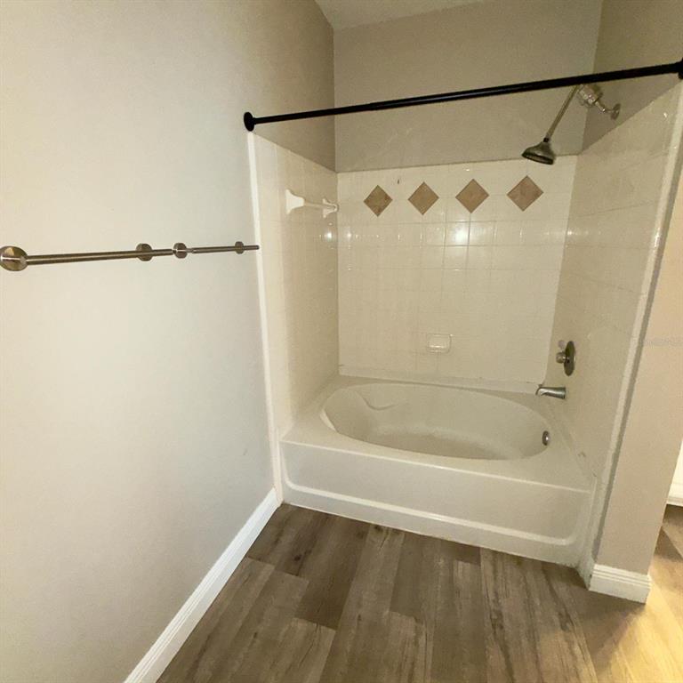 12861 Madison Pointe Circle, Unit 101 Orlando, FL 32821 - Photo 18 of 30 a bathroom with a shower and a bath tub