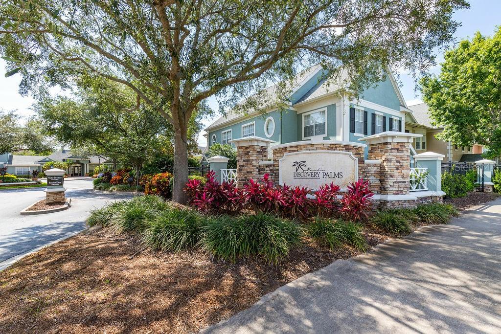 12861 Madison Pointe Circle, Unit 101 Orlando, FL 32821 - Photo 2 of 30 a front view of a house with a garden and pathway