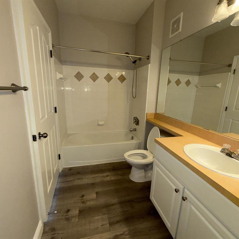 12861 Madison Pointe Circle, Unit 101 Orlando, FL 32821 - Photo 21 of 30 a bathroom with a sink a toilet and shower