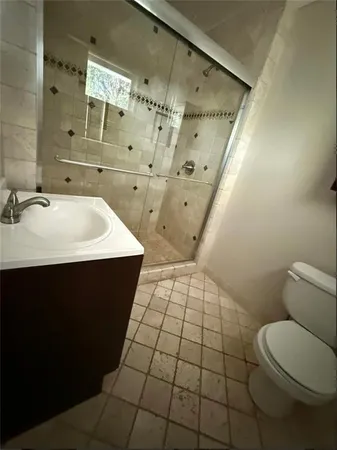 a bathroom with a sink toilet and shower