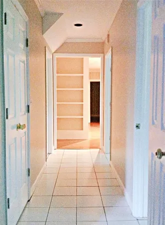 a view of room with window and a hallway