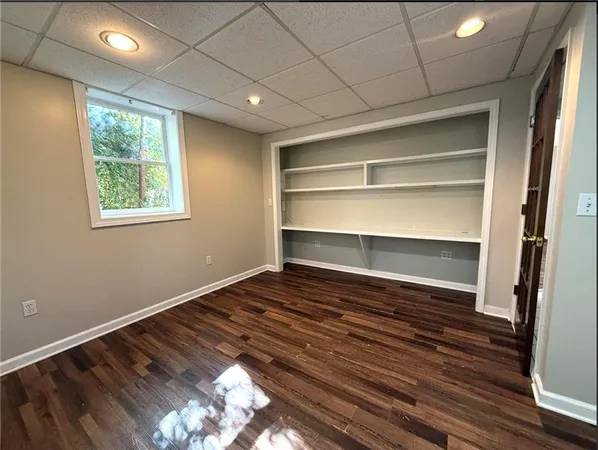 a view of room with window and wooden floor