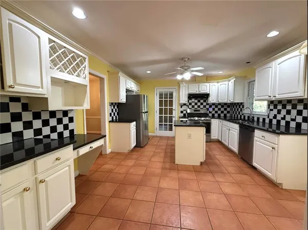 a kitchen with stainless steel appliances a refrigerator sink and cabinets