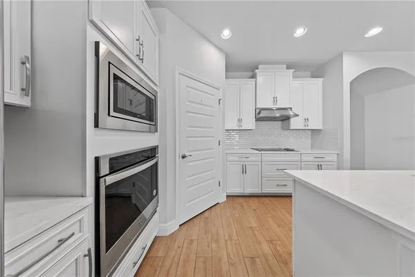 a kitchen with stainless steel appliances a stove sink and refrigerator