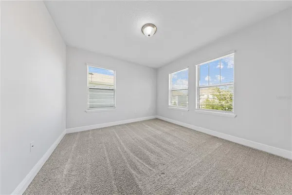 a view of a room with wooden floor and a bathroom