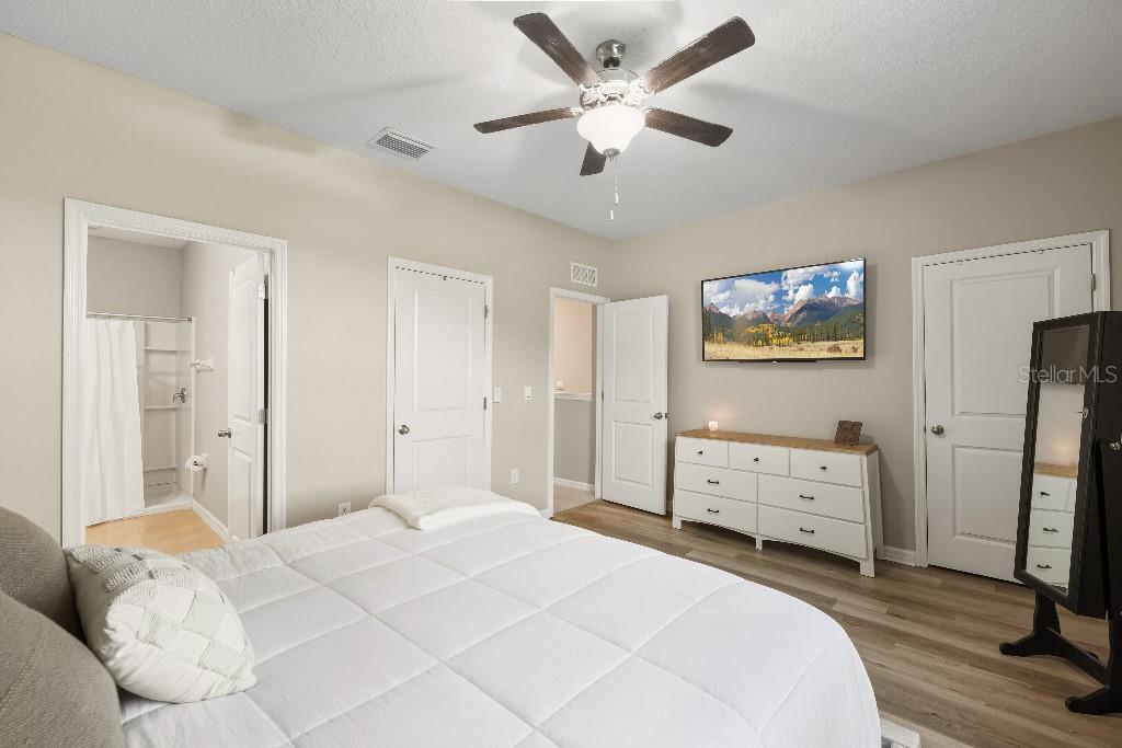 13664 Northwest 9th Road Newberry, FL 32669 - Photo 13 of 33 a bedroom with a bed and a chandelier