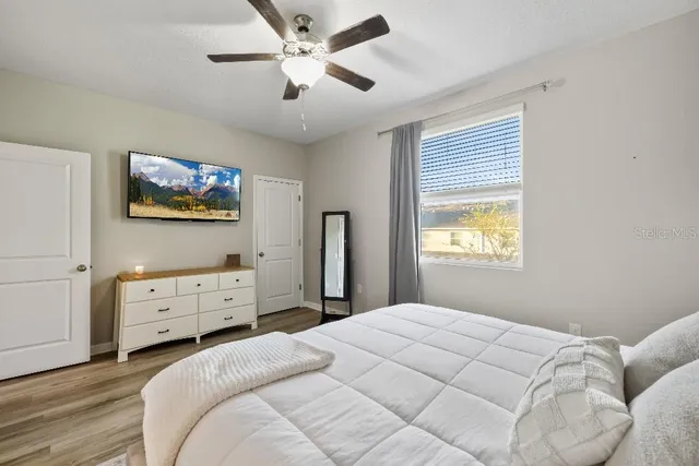 a bedroom with a bed and a tv