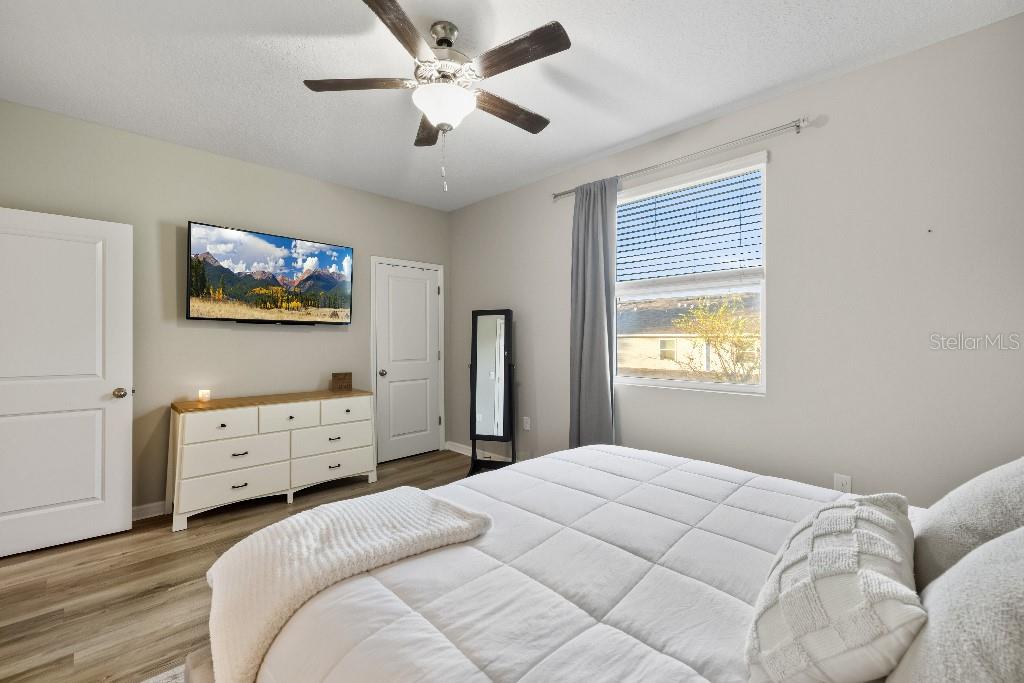 13664 Northwest 9th Road Newberry, FL 32669 - Photo 16 of 33 a bedroom with a bed and a tv